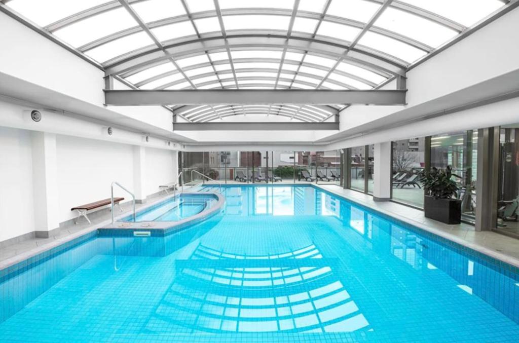 a large swimming pool with a glass ceiling at 222 Stay on Russell in Melbourne