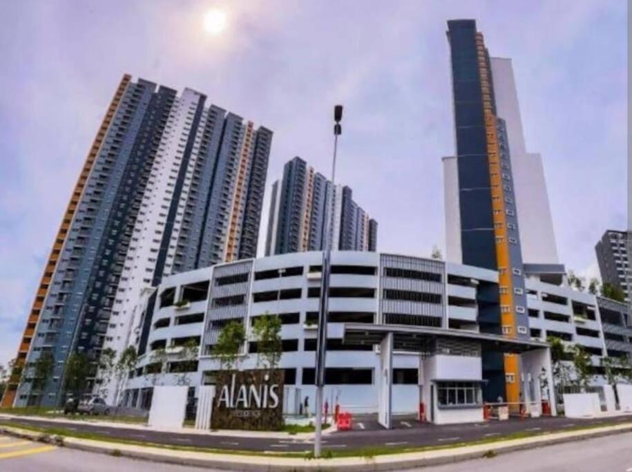 a large building in front of some tall buildings at Alanis Residence@KLIA in Sepang