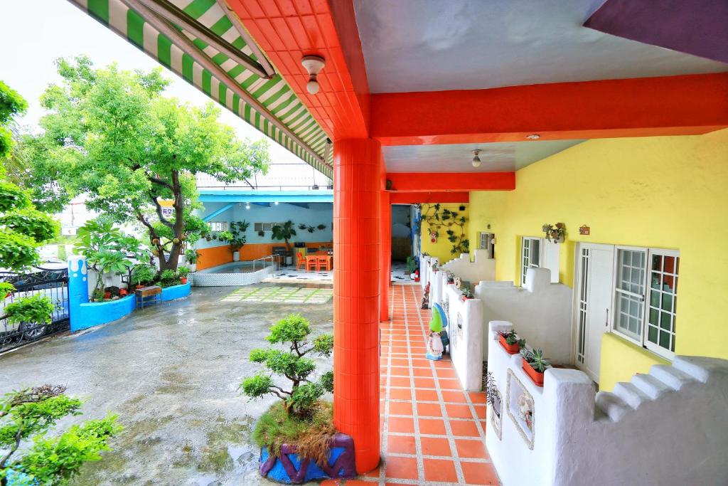 an outside view of a building with red columns at Fumigate Hotel in Hengchun South Gate