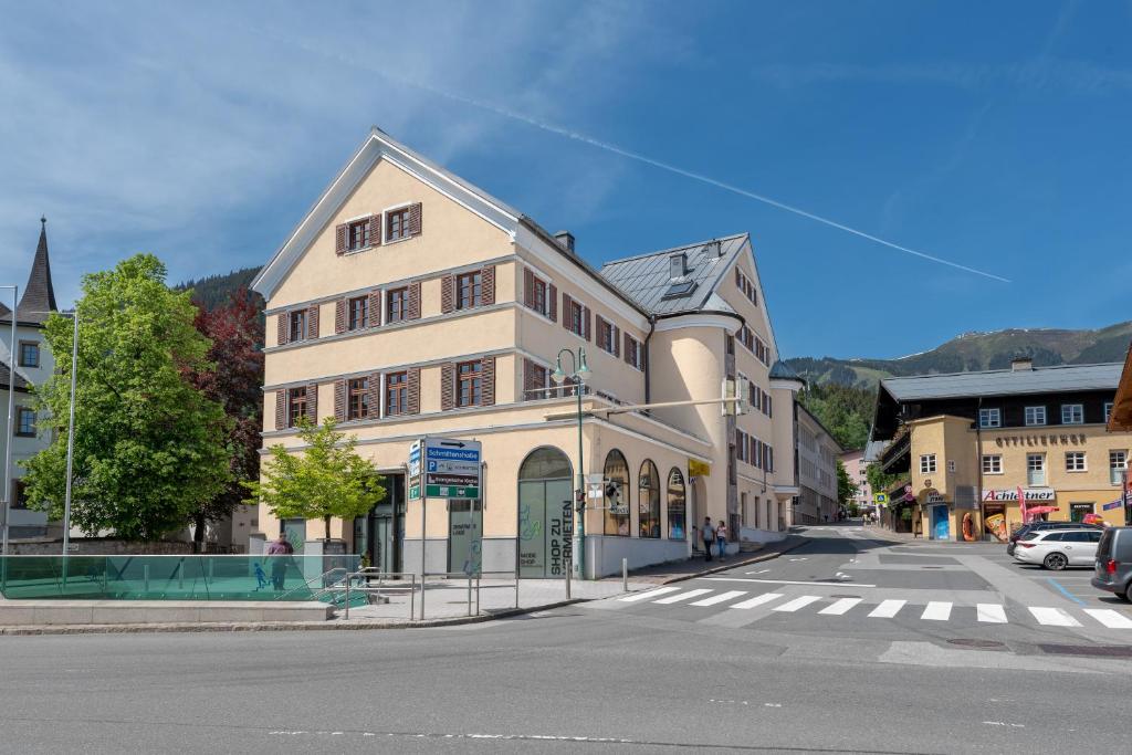 a building on the corner of a city street at Post Residence Apartments by All in One Apartments in Zell am See