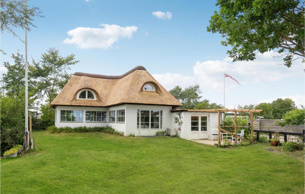 a house with a thatched roof and a yard at Gorgeous Home In Middelfart With Wifi in Middelfart