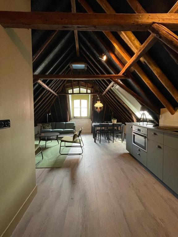 a large room with a kitchen and a living room at B&B Hoogstraat in Dokkum
