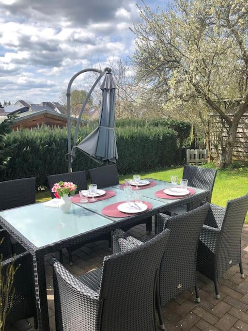 an outdoor table with chairs and a lamp at Ferienwohnung Eifel-Roedis in Blankenheim