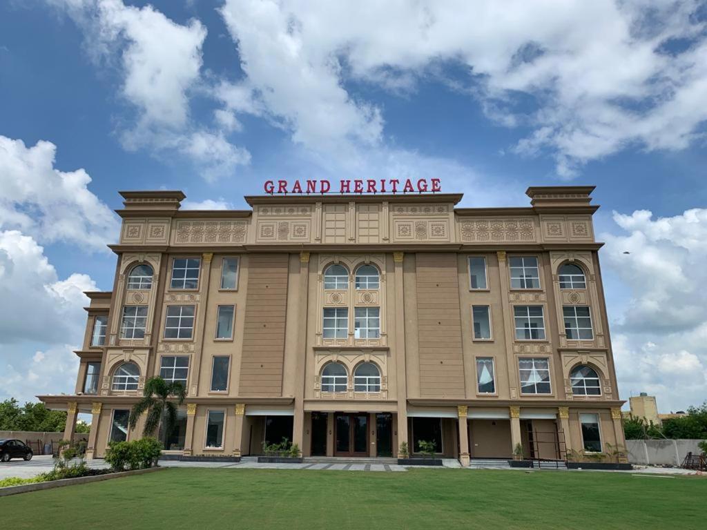 a large building with a sign on top of it at Grand Heritage Hotel & Resort in Ludhiana