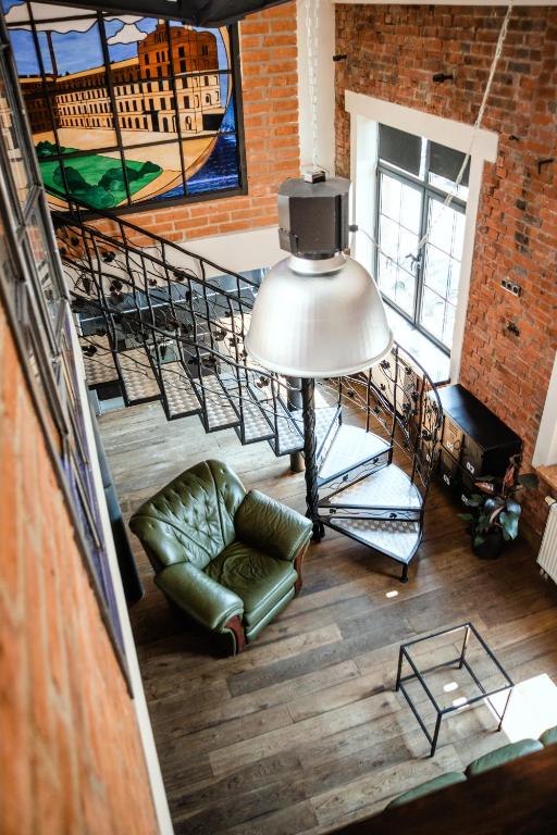 a living room with a staircase and a couch at RedCity Loft 25 in Żyrardów