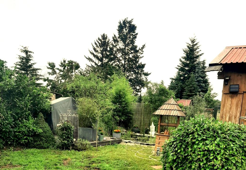 a garden with a gazebo and a fence at Haus Waldblick in Liebenwalde