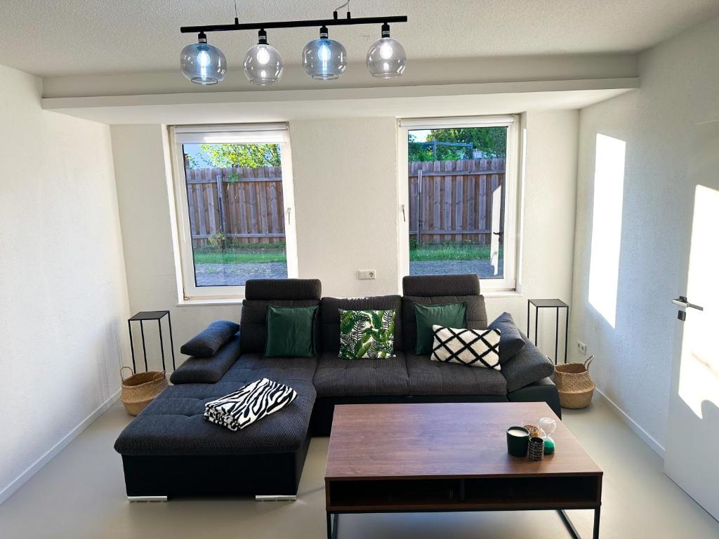 a living room with a couch and a table at Moderne FeWo in HDZ&Klinik Nähe in Bad Oeynhausen