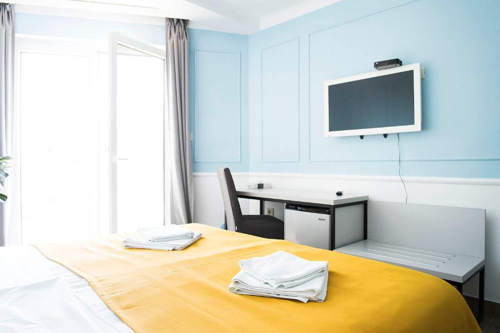Posteľ alebo postele v izbe v ubytovaní Hotel Plaza