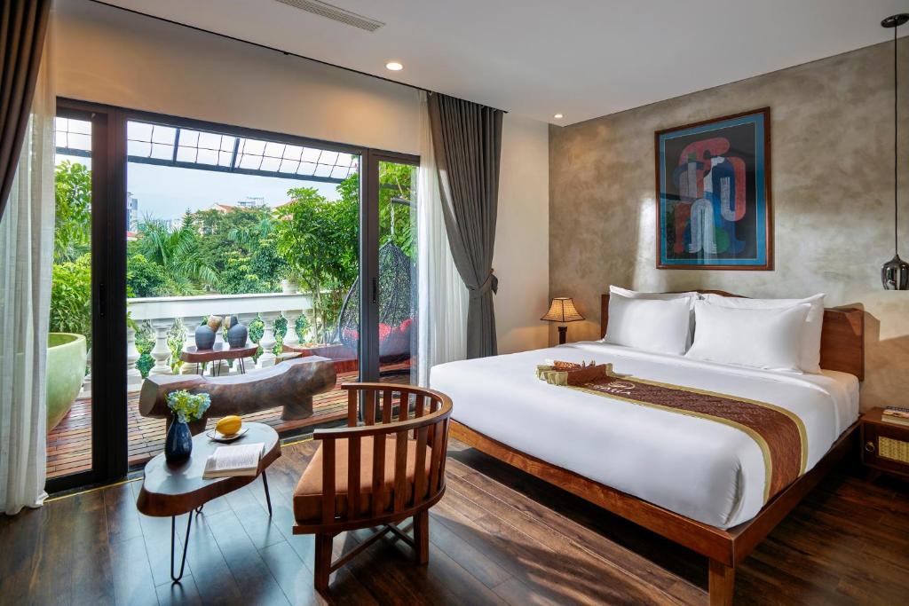 a bedroom with a large bed and a large window at Draha Halong Hotel in Ha Long