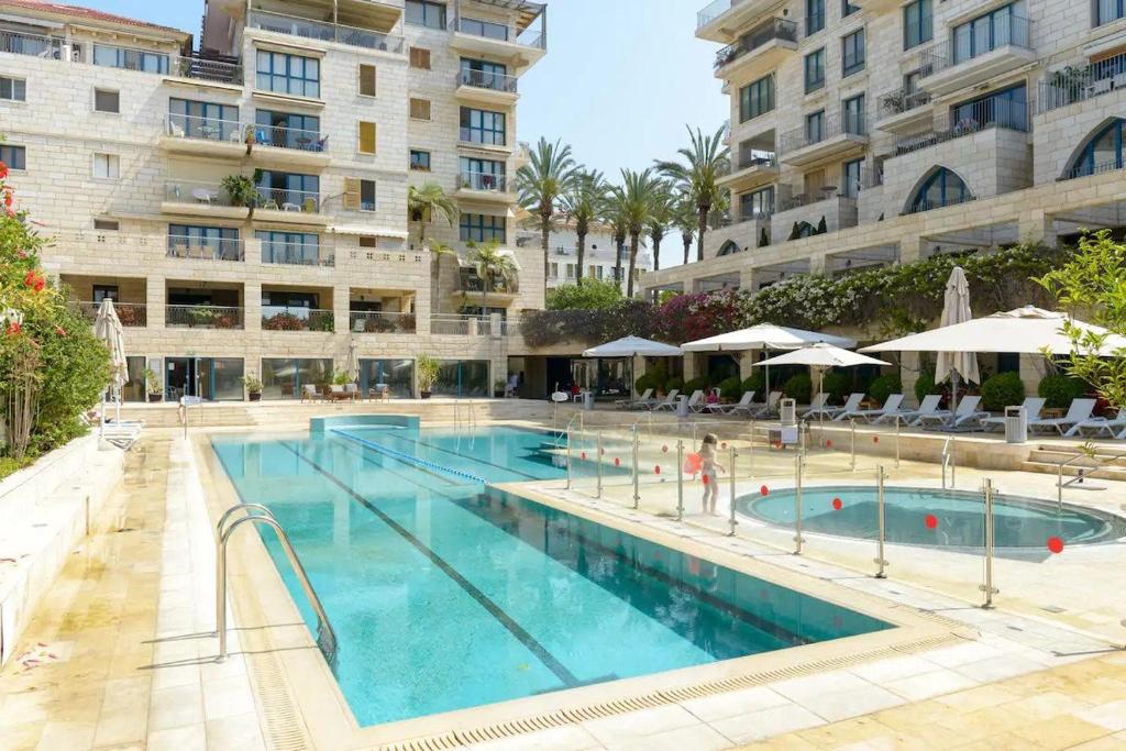 una gran piscina frente a un edificio en ANDRO LUX 2BR apartment with pool in Old Jaffa, en Tel Aviv