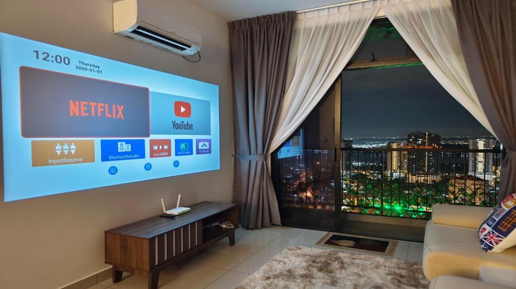 a living room with a large window and a tv at Twin Tower Johor Bahru by Glex in Johor Bahru