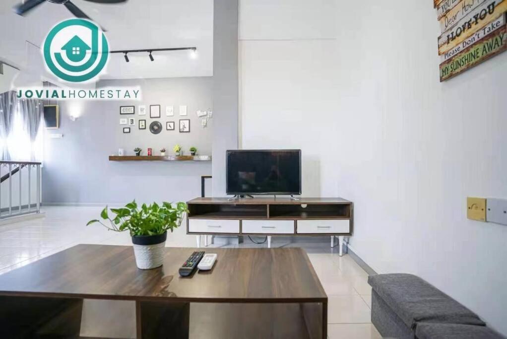 a living room with a tv and a coffee table at Jovial Modern Stylish Townhouse 8pax - BM Icon City in Bukit Mertajam