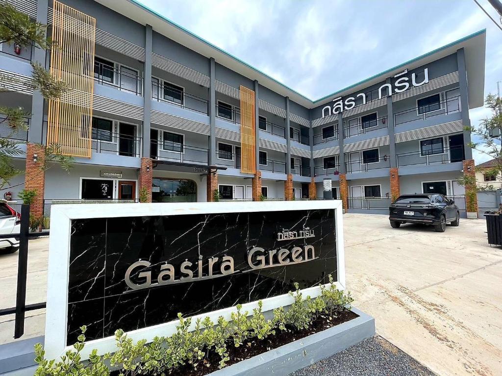 a building with a sign in front of it at Gasira Green in Ban Tha Kham
