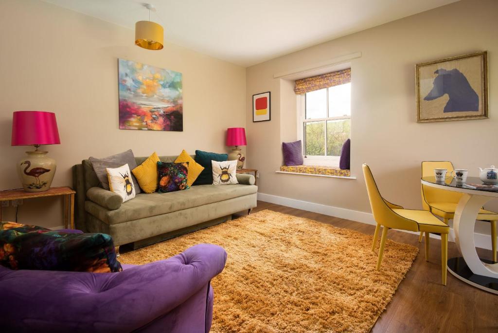 a living room with a couch and a table at Walltown Farm Cottage in Brampton