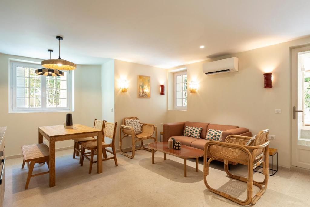 un salon avec un canapé, une table et des chaises dans l'établissement Modern Luxury Apartment 6 pax, à Cannes