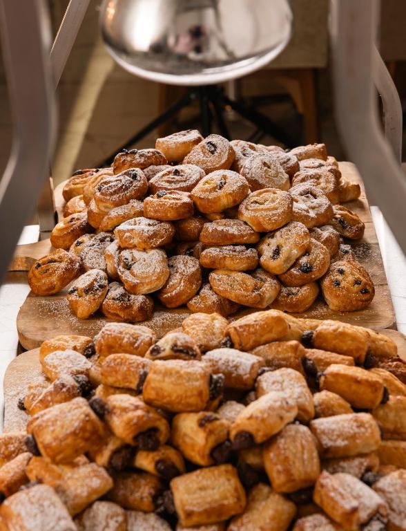 a pile of donuts and other pastries on a table at Vivaldi Hotel in St. Julianʼs