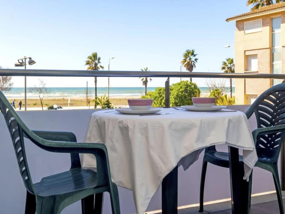 a table and chairs on a balcony with the beach at Stay Barcelona - Castelldefels in Castelldefels