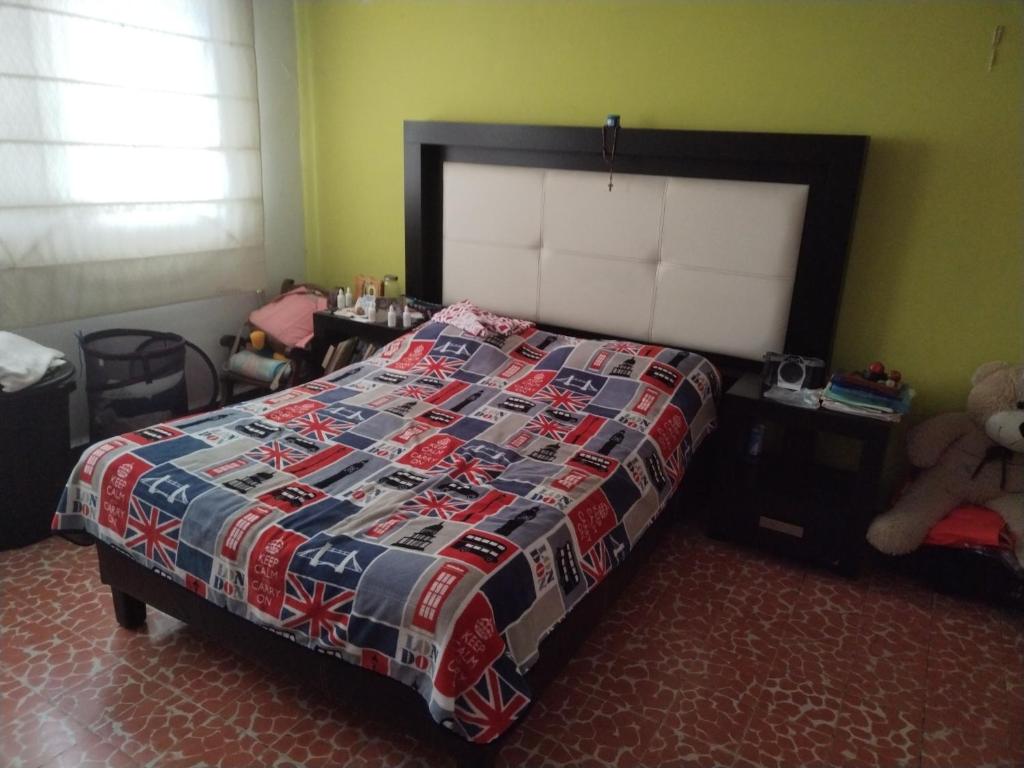 a bedroom with a bed and a teddy bear at Casa CODHE - Sebastián Galicia Carrera in Córdoba