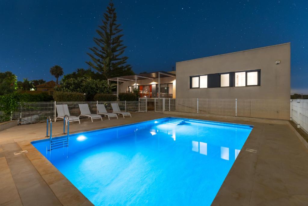 a swimming pool in front of a house at night at Sunshine Villa by Fidalsa in Los Montesinos