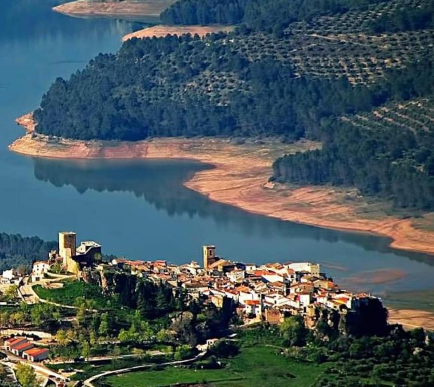 a small village on the shore of a lake at El Cruce Hornos in Hornos