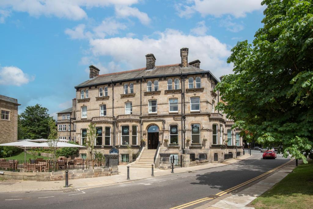 a large stone building on a city street at The Harrogate Inn - The Inn Collection Group in Harrogate