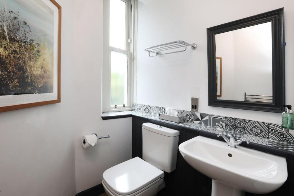 a bathroom with a white toilet and a sink at The Harrogate Inn - The Inn Collection Group in Harrogate