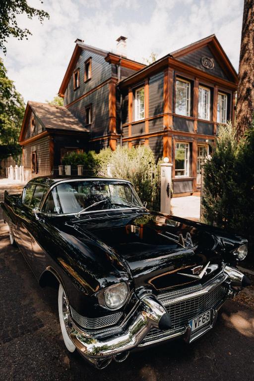 a black car parked in front of a house at Exquisite 1930's Historical House in Jūrmala