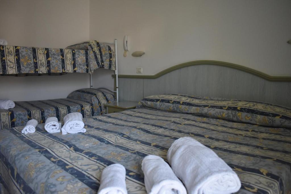 Postel nebo postele na pokoji v ubytování Hotel Ginevra e Residence