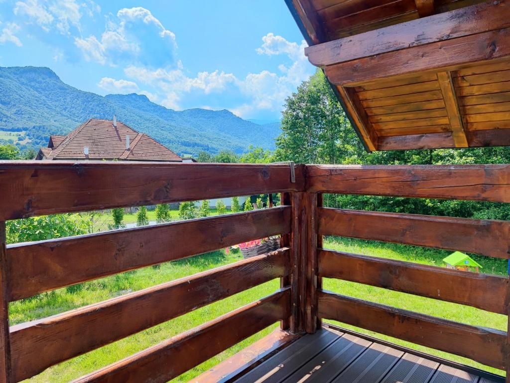 a wooden fence with a view of the mountains at Zen House Bran in Bran