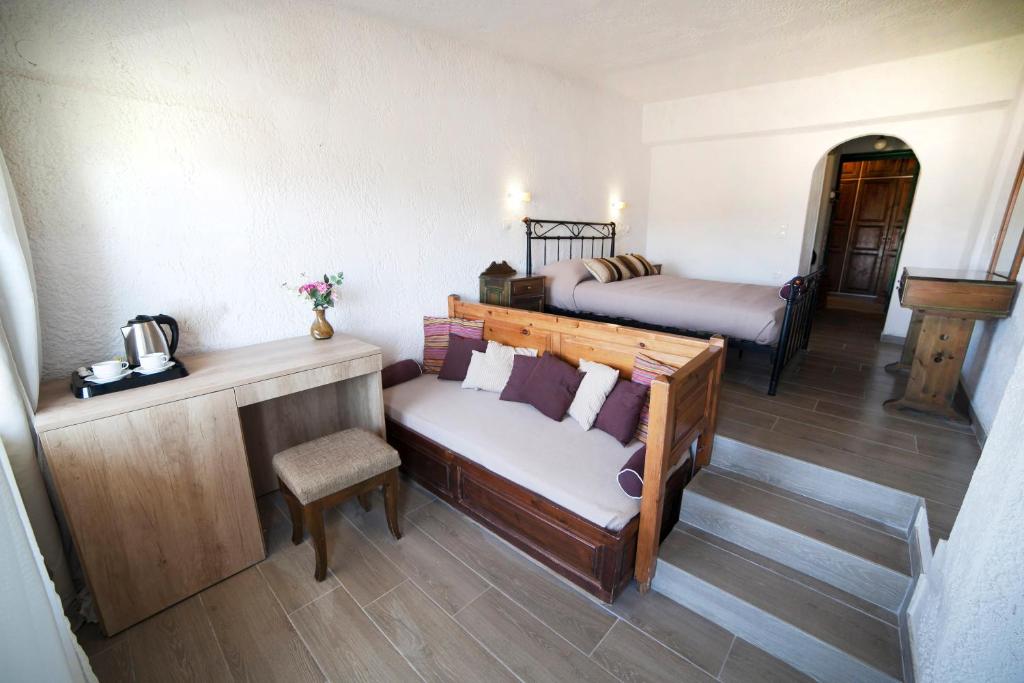 a room with a couch and a bed in a room at Elpida Village in Istro