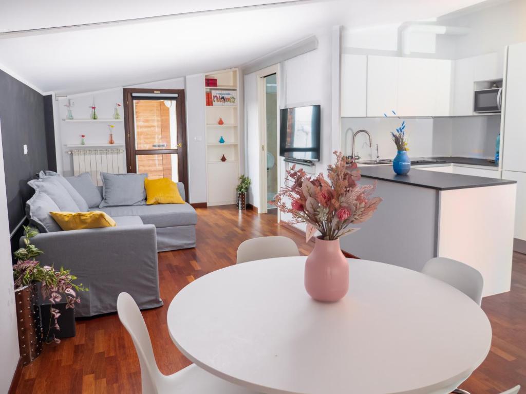 a kitchen and living room with a table and a couch at Minià in Pescara