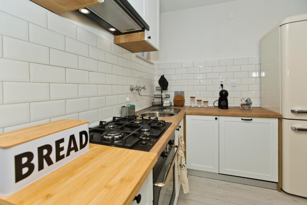 a kitchen with a stove top oven next to a counter at Robinson house T'n'T in Hvar