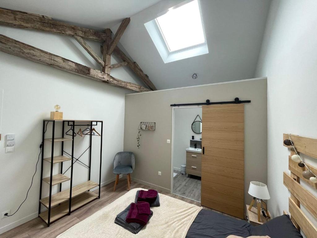 a bedroom with a bed and a window and a mirror at Les Iris - Chambre Chêne in Avanton