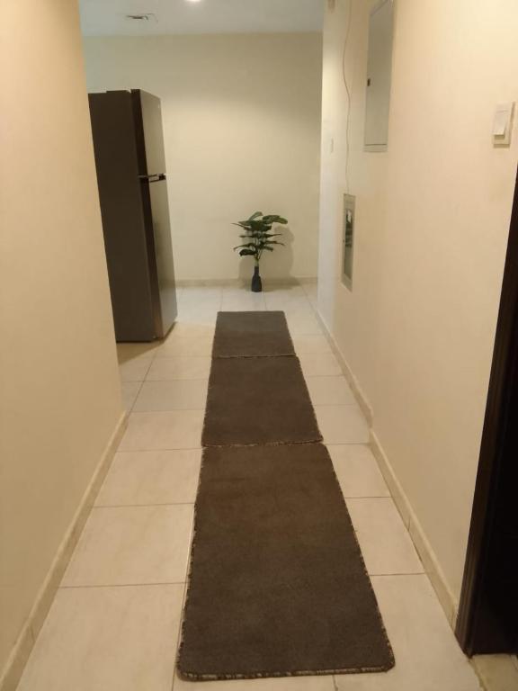 a long hallway with a rug on the floor at golden land in Sharjah