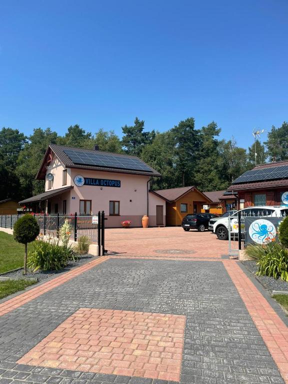 a parking lot in front of a building at Villa OCTOPUS in Dąbki