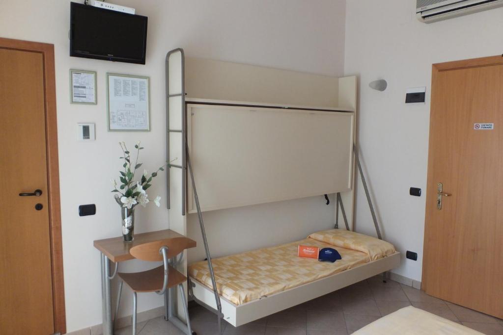 Postel nebo postele na pokoji v ubytování Hotel Nettuno
