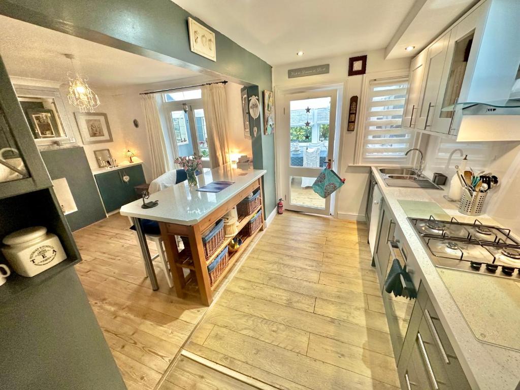 a kitchen with a sink and a counter top at Garden Cottage - 3 Bedroom Close to Town and Beach in Bournemouth