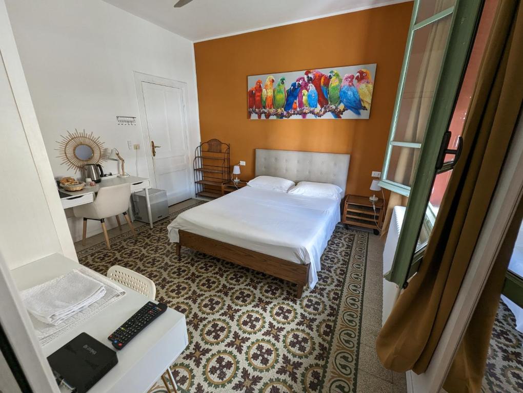 a hotel room with a bed and a desk with a desk at Villa Corsini in Laigueglia