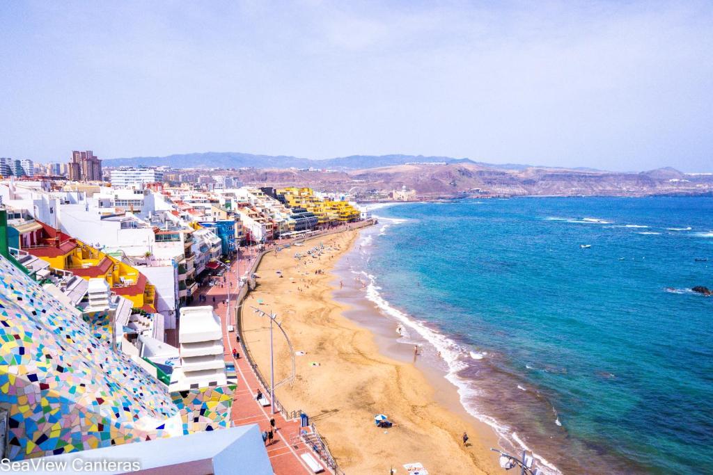 a view of a beach with buildings and the ocean at Seaview Canteras in Las Palmas de Gran Canaria