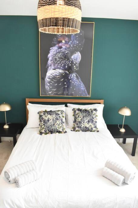 a bedroom with a white bed with a picture on the wall at 2 Bedroom Apartment in Gateshead in Gateshead