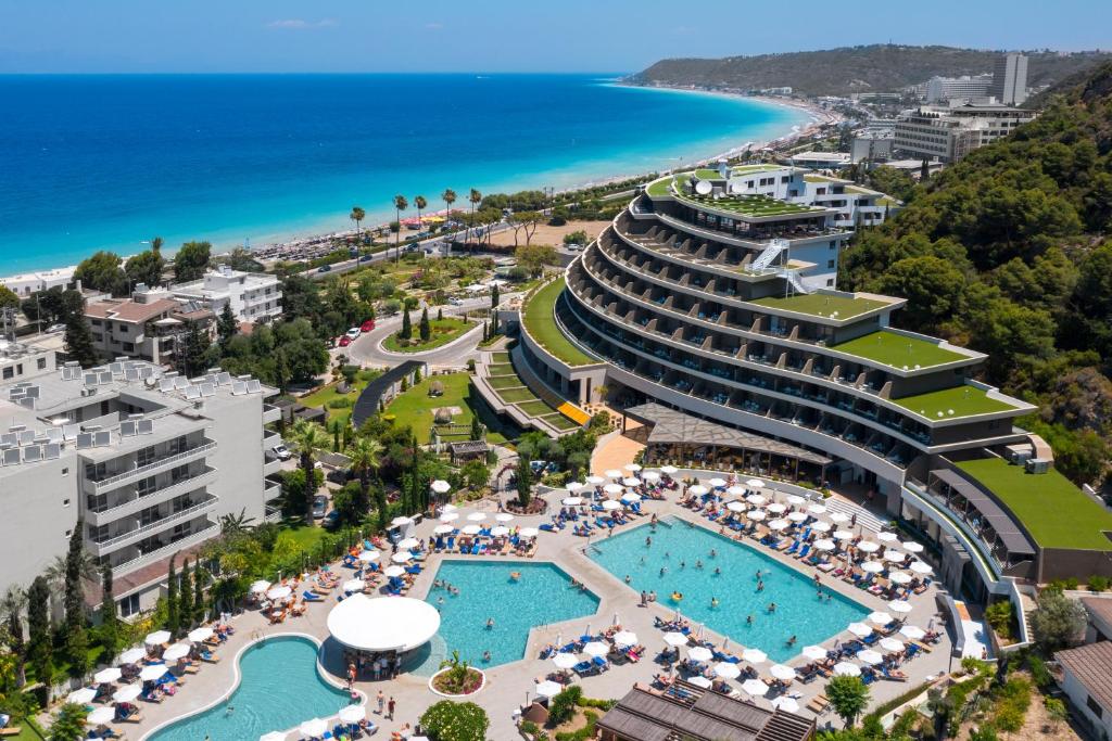an aerial view of a resort with a pool and the ocean at Olympic Palace Hotel in Ixia