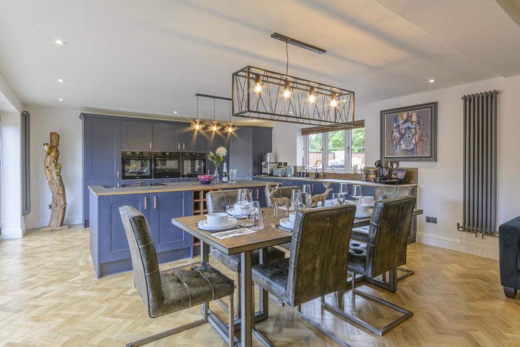 a dining room and kitchen with a table and chairs at Ketley Vallens in Telford