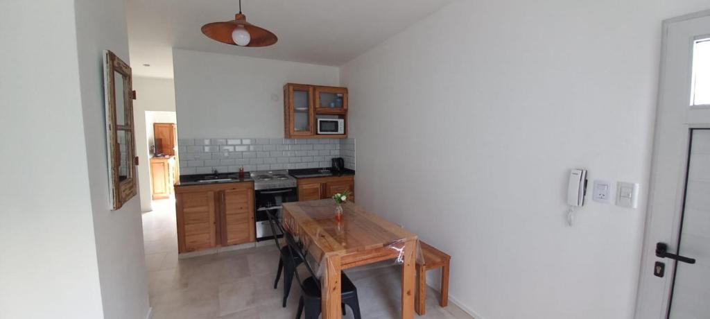 a kitchen with a wooden table in a room at EL CARMEL in Paraná