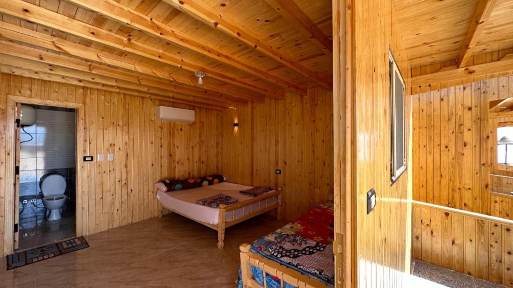 a bedroom with a bed in a wooden cabin at Musa Camp in Nuweiba