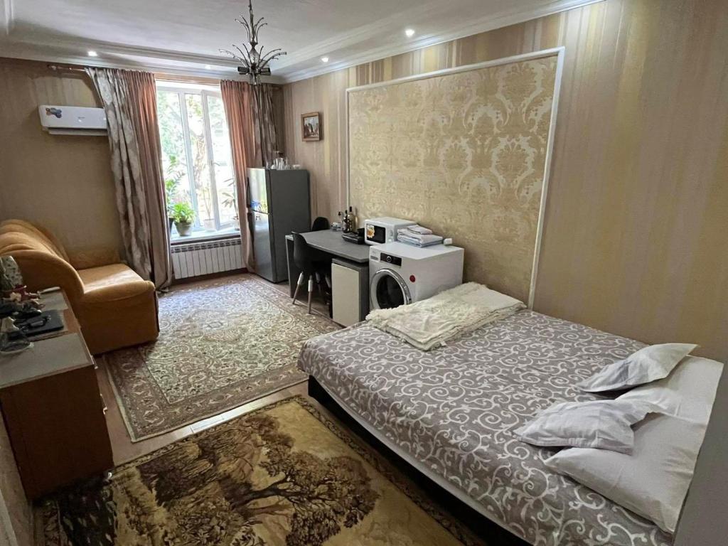 a hotel room with a bed and a desk and a desk at Golden Hotel in the Center in Chişinău