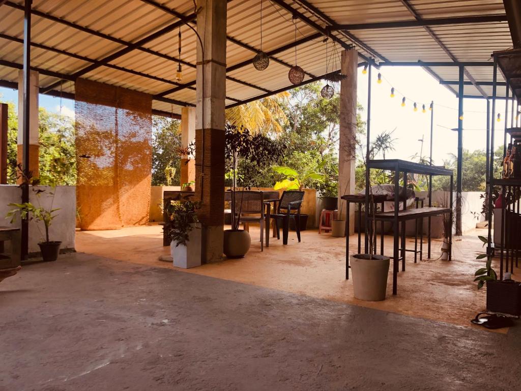 a patio with tables and chairs in a building at Airport Layover B&B in Katunayaka