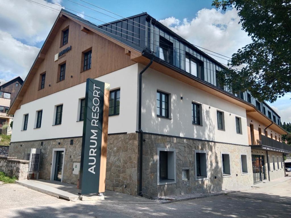 un edificio con una señal delante de él en Resort Aurum Residence A, en Černý Důl