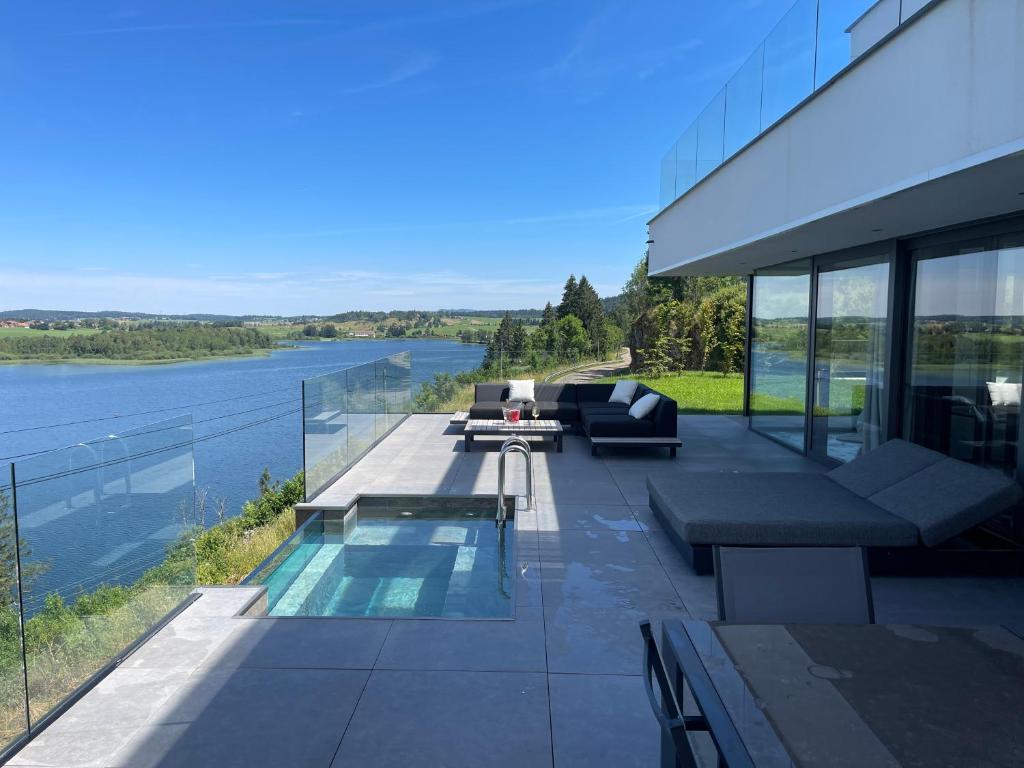 a house with a patio with a view of the water at Le Nordic in Grande Riviere