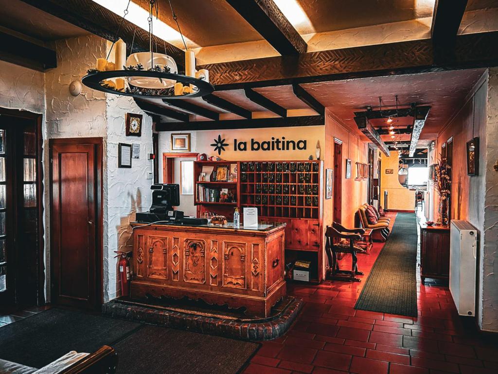 a library with a wooden desk in a room at Hotel Ristorante La Baitina in Asiago