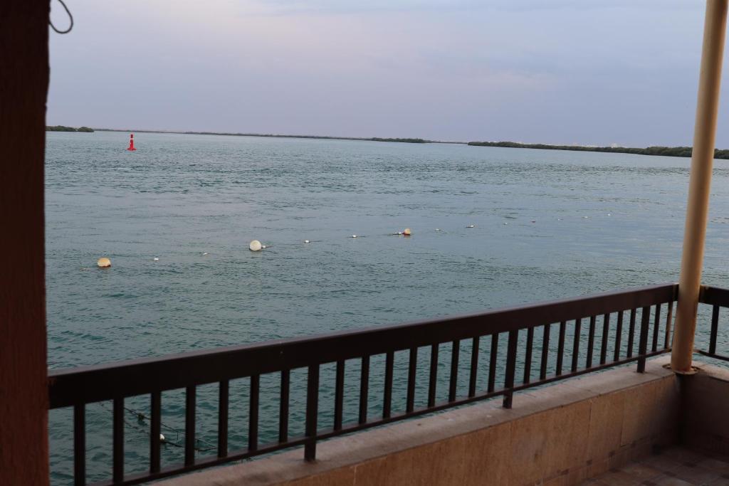a view of a body of water from a balcony at Flamingo Beach Hotel in Umm Al Quwain